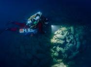 An archeologist examines an underwater site. Source.