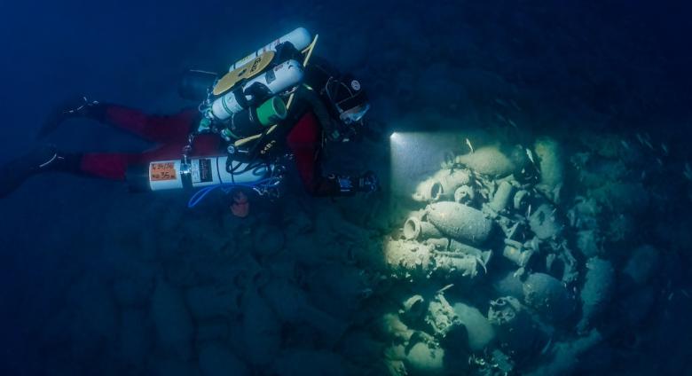 An archeologist examines an underwater site. Source.